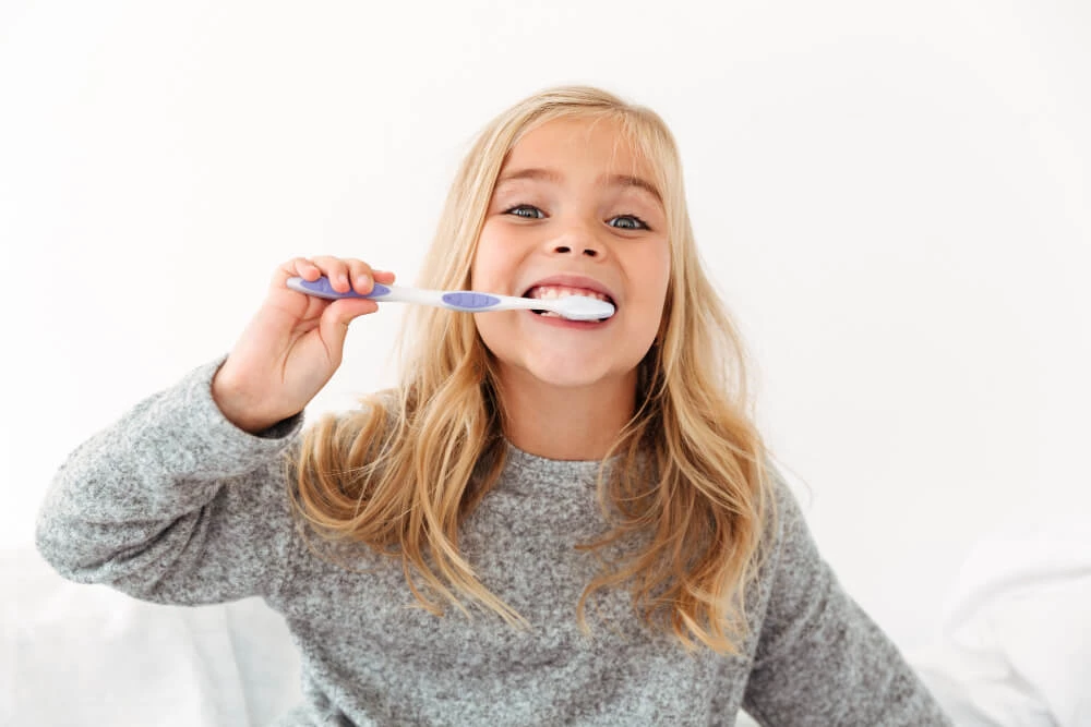 Close Up Portrait Cute Kid Gray Pajamas Brushing Her Teeth (1)